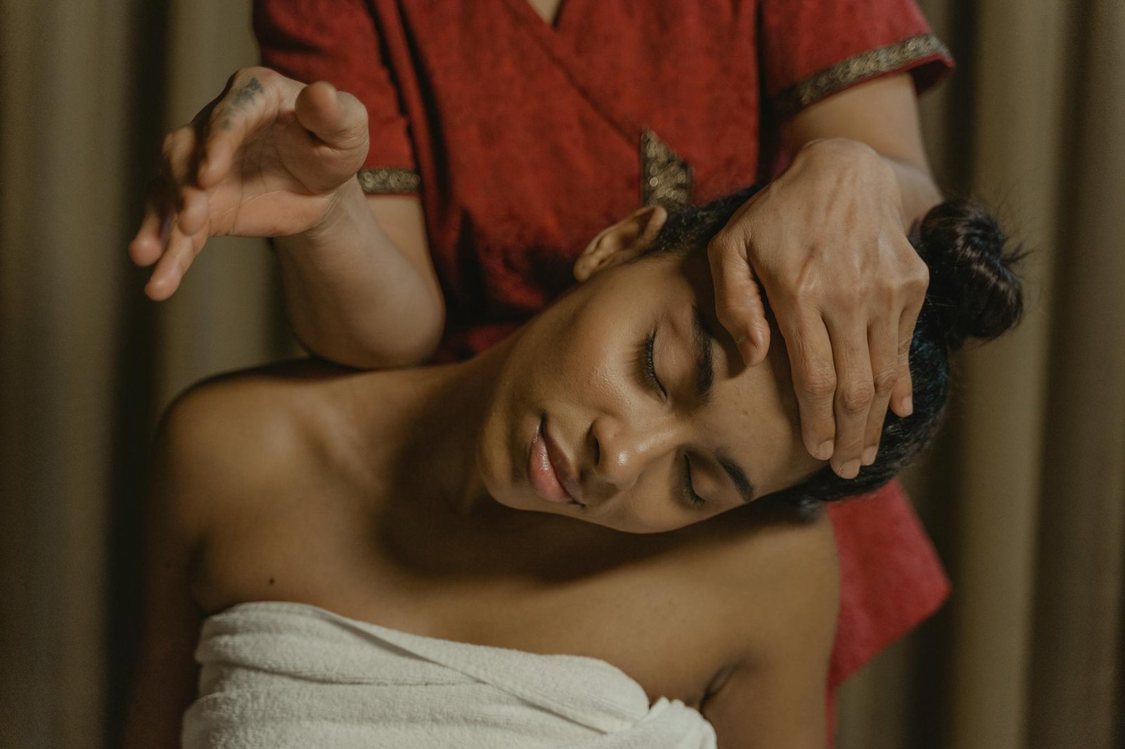 A serene moment of a woman enjoying a soothing massage session for wellness and relaxation.